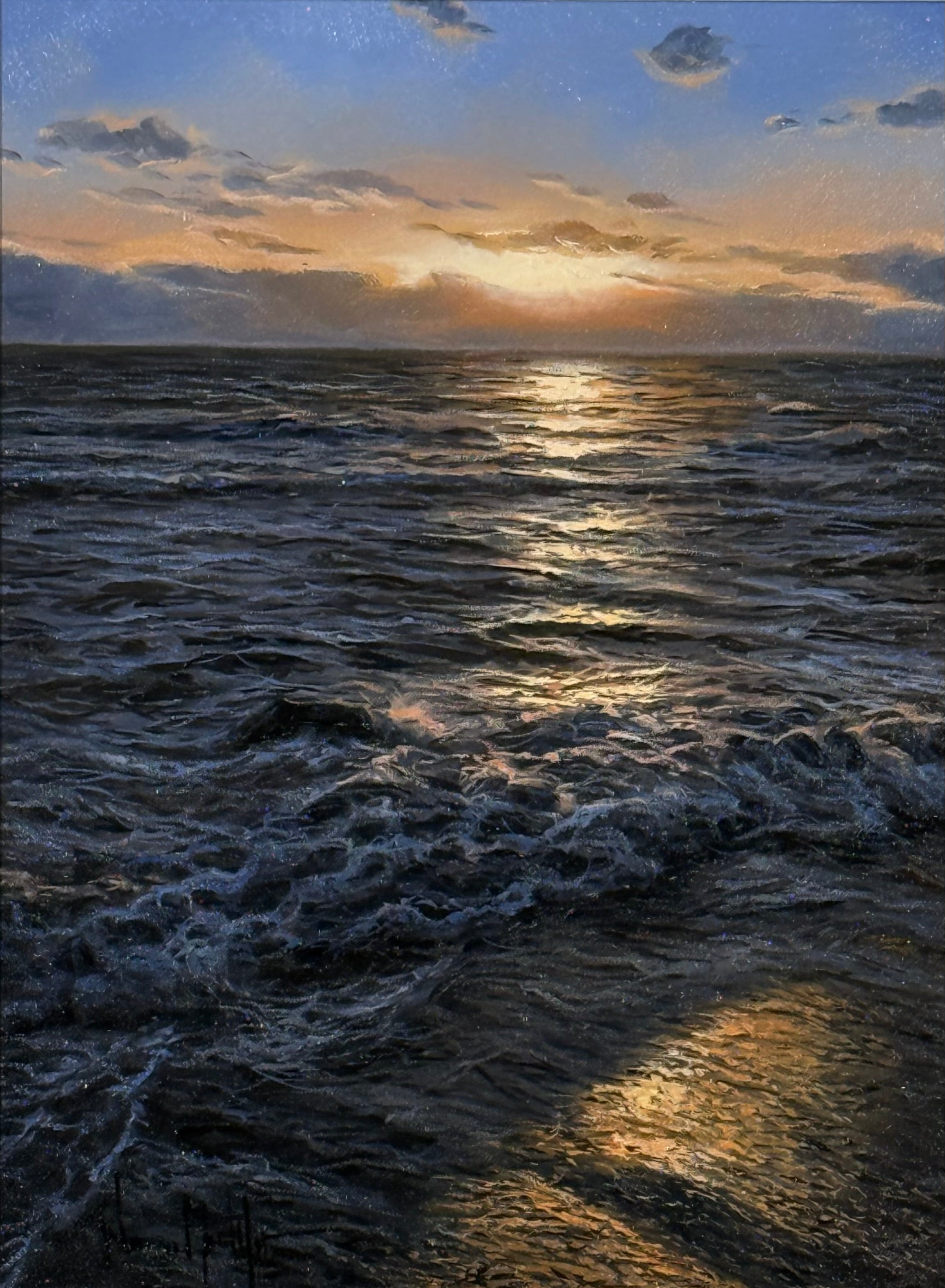 Sunset over a rough sea with waves and clouds.