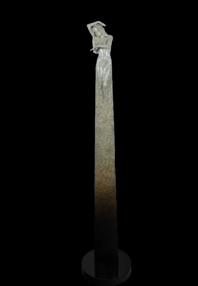 Decorative column with a statue on top against a black background