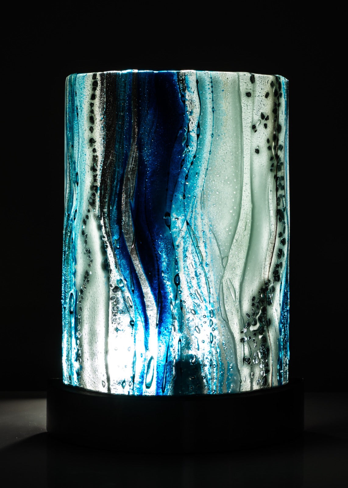 Decorative lamp with blue and white pattern on a black background