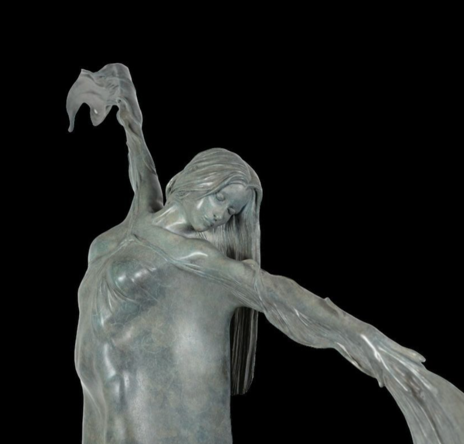 Statue of a woman with outstretched arms on a black background