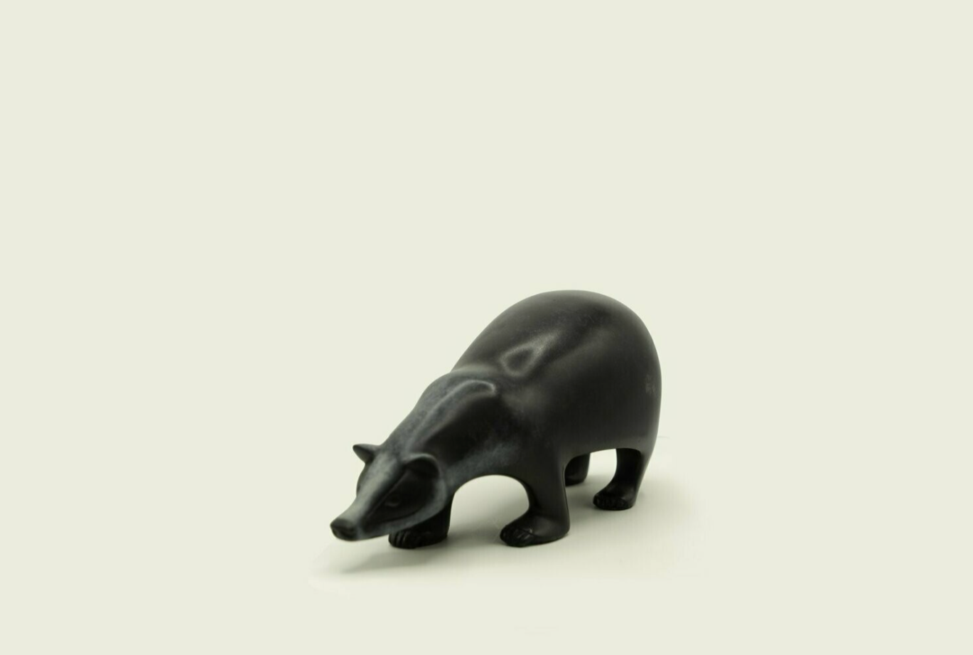 Black bear figurine on a beige background