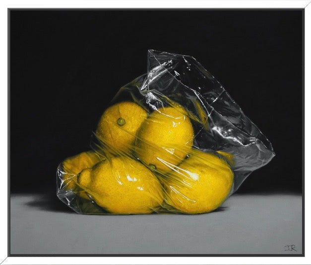 Pastel drawings Clear plastic bag with lemons on a gray surface and black background