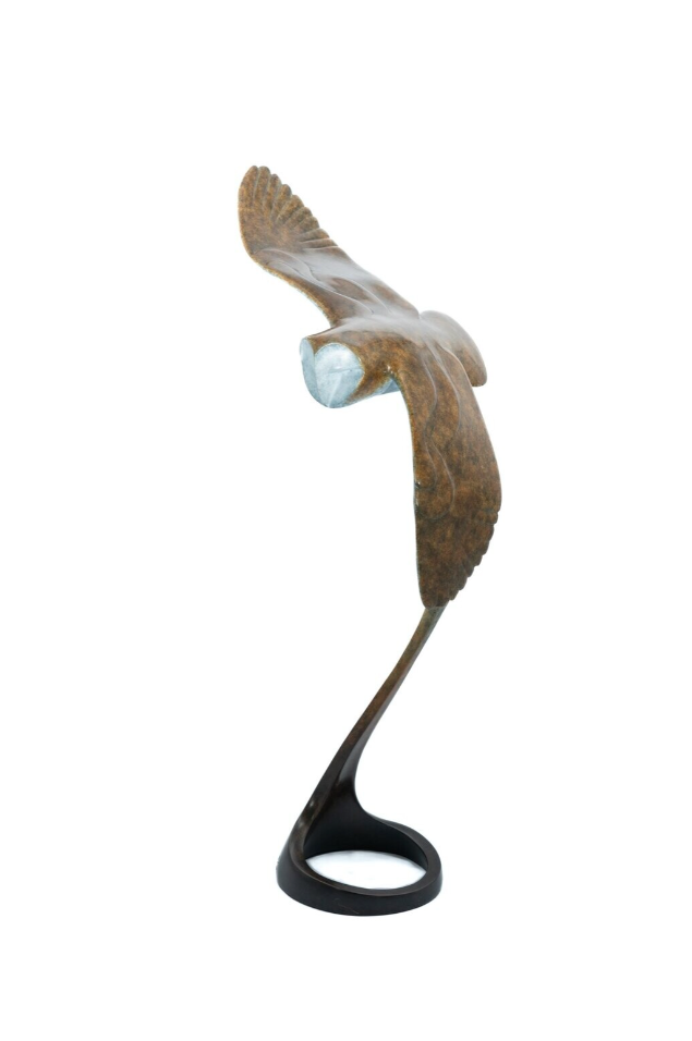 Statue of a bird in flight on a white background
