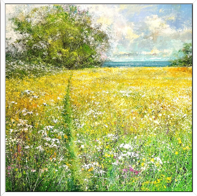 Contemporary landscape painting of a field with bright yellow flowers leading to the sea with a blue sky above framed in a white frame