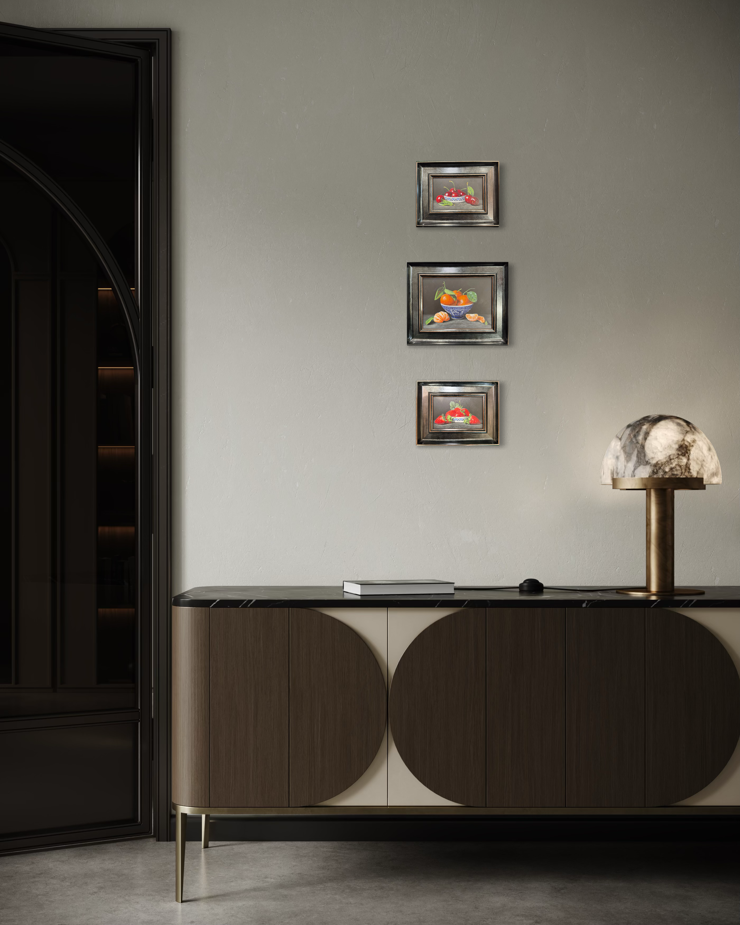 Modern interior with a sideboard, lamp, and wall art on a gray wall.