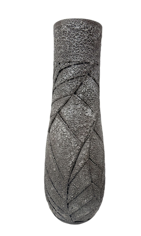 Textured black and gray object on a white background