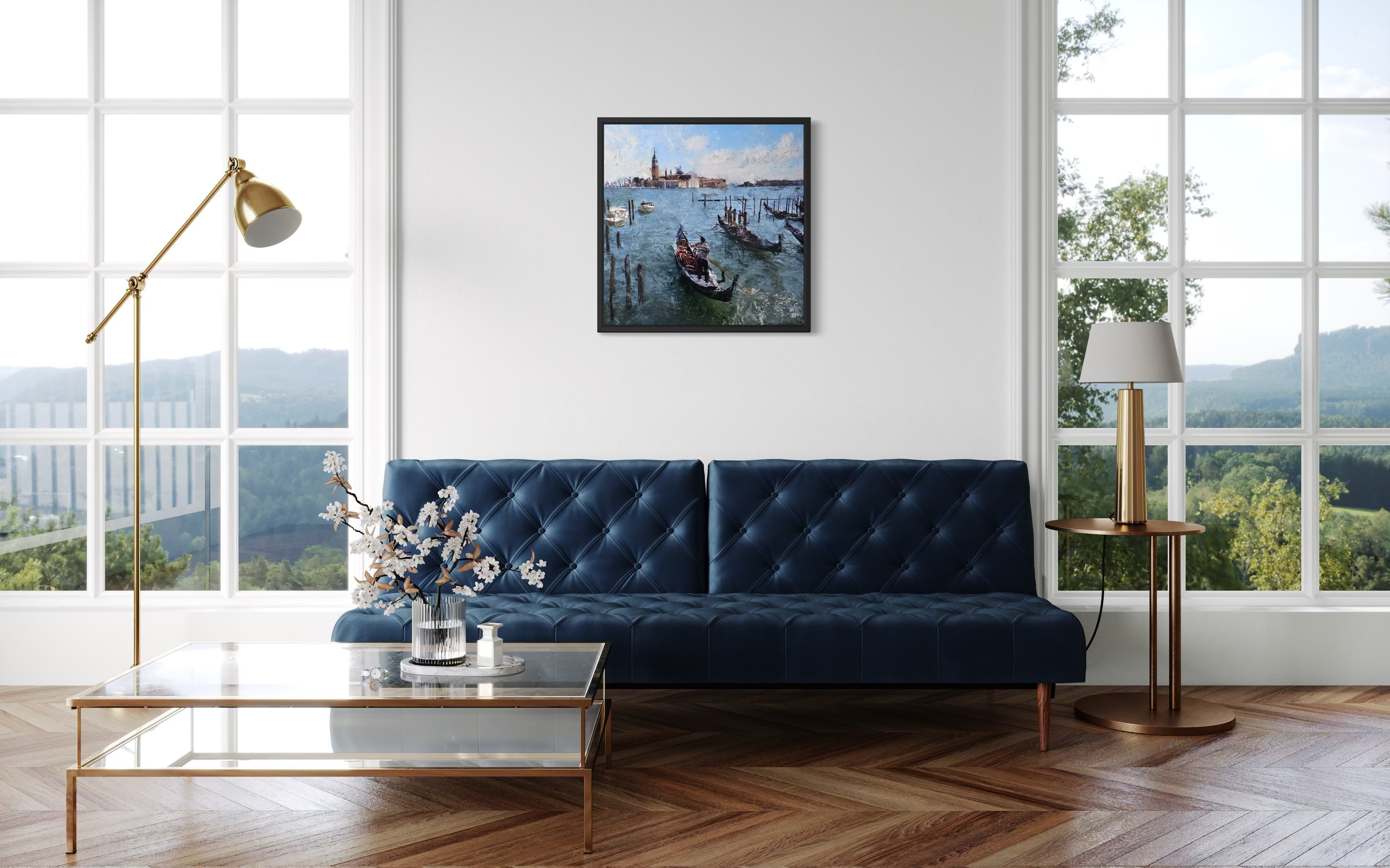 Modern living room with a blue sofa, coffee table, and decorative elements, with an original mixed media painting by Ben Ark hanging centra
