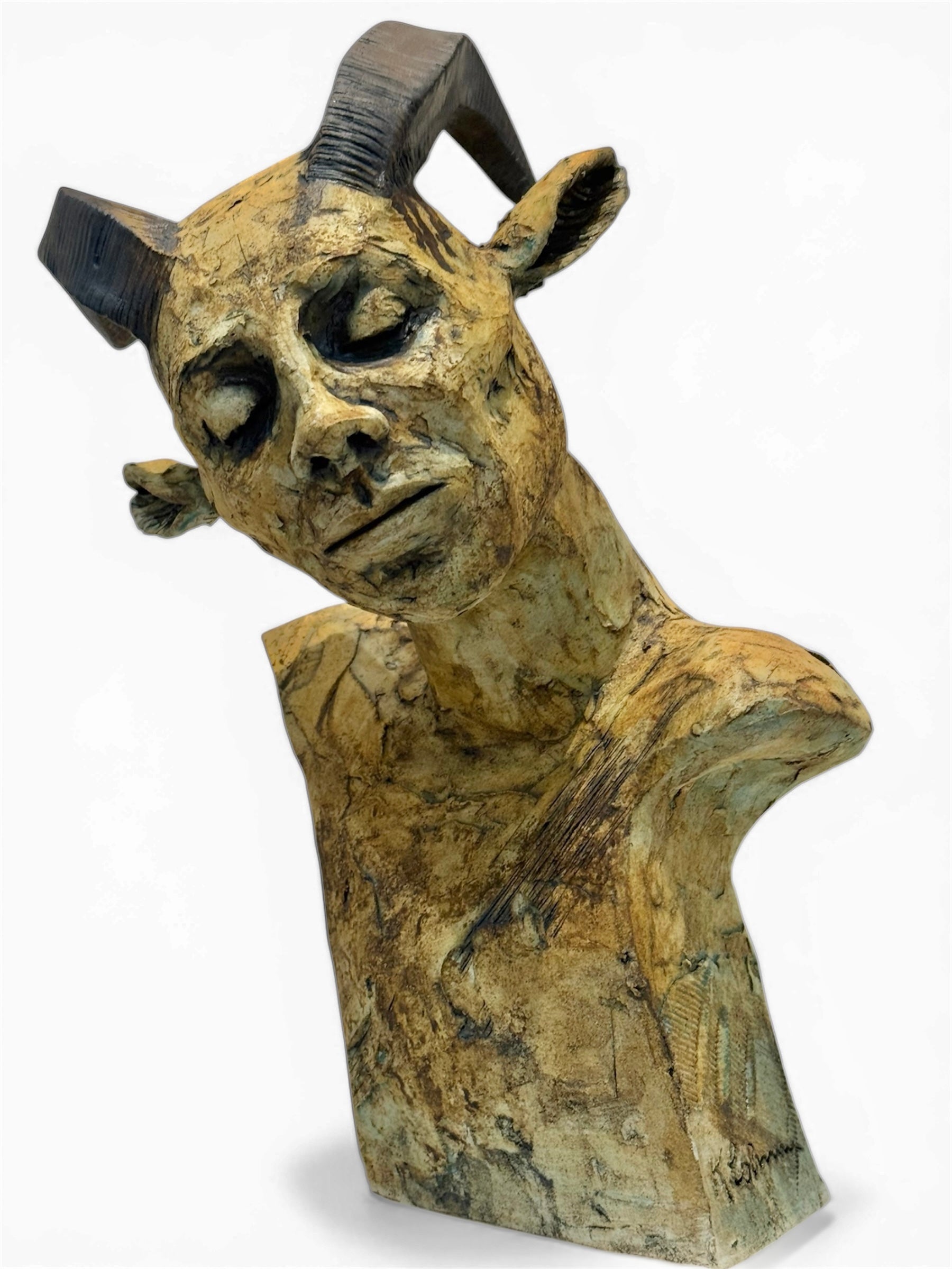 ceramic sculpture of a bust with goat-like features on a white background