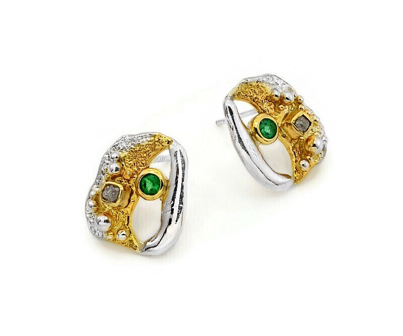 Pair of gold and silver earrings with green gemstones on a white background