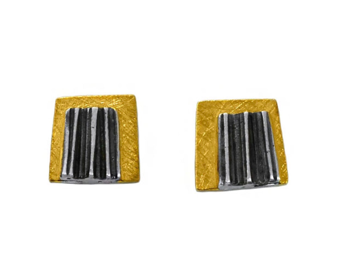 Pair of square earrings with gold and black design on a white background