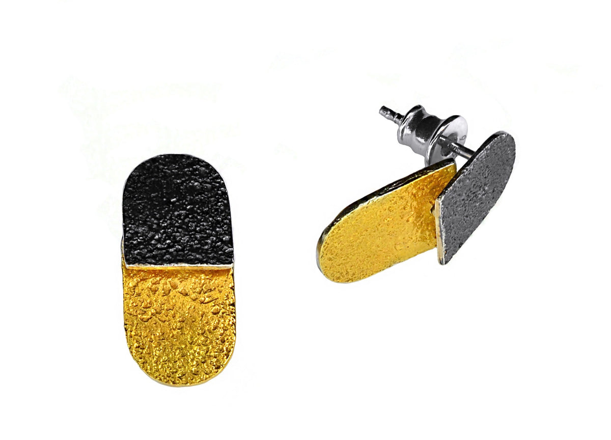 Pair of earrings with black and gold design on a white background