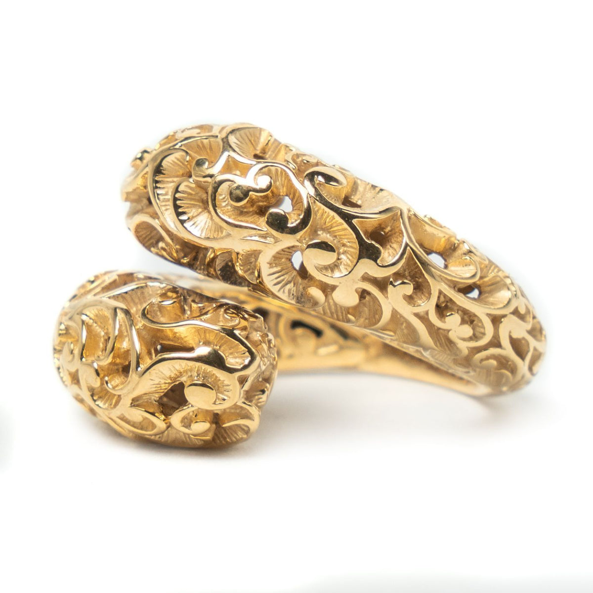 Gold bracelet with intricate designs on a white background