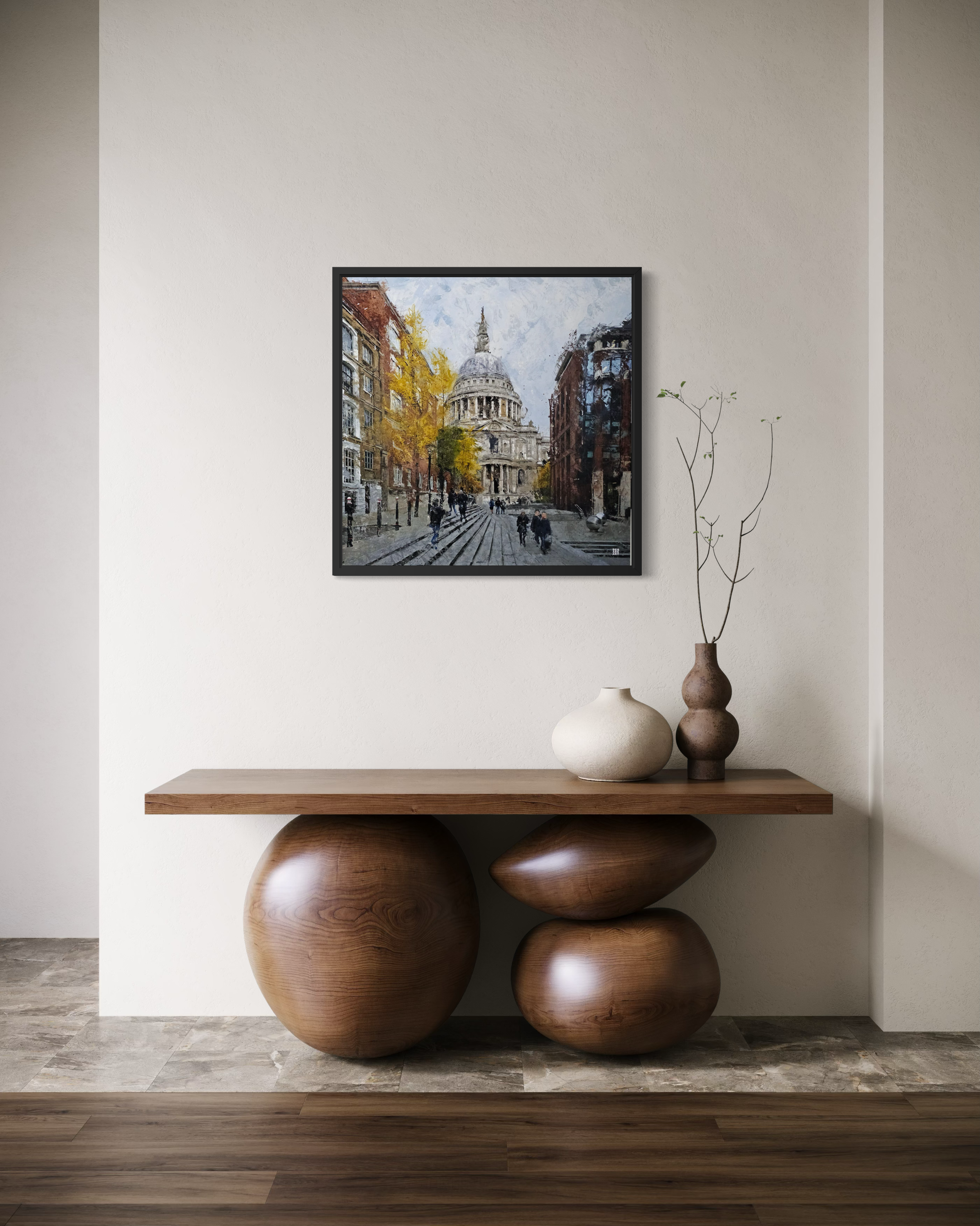 Wooden console table with decorative items against a wall with a framed Ben Ark painting
