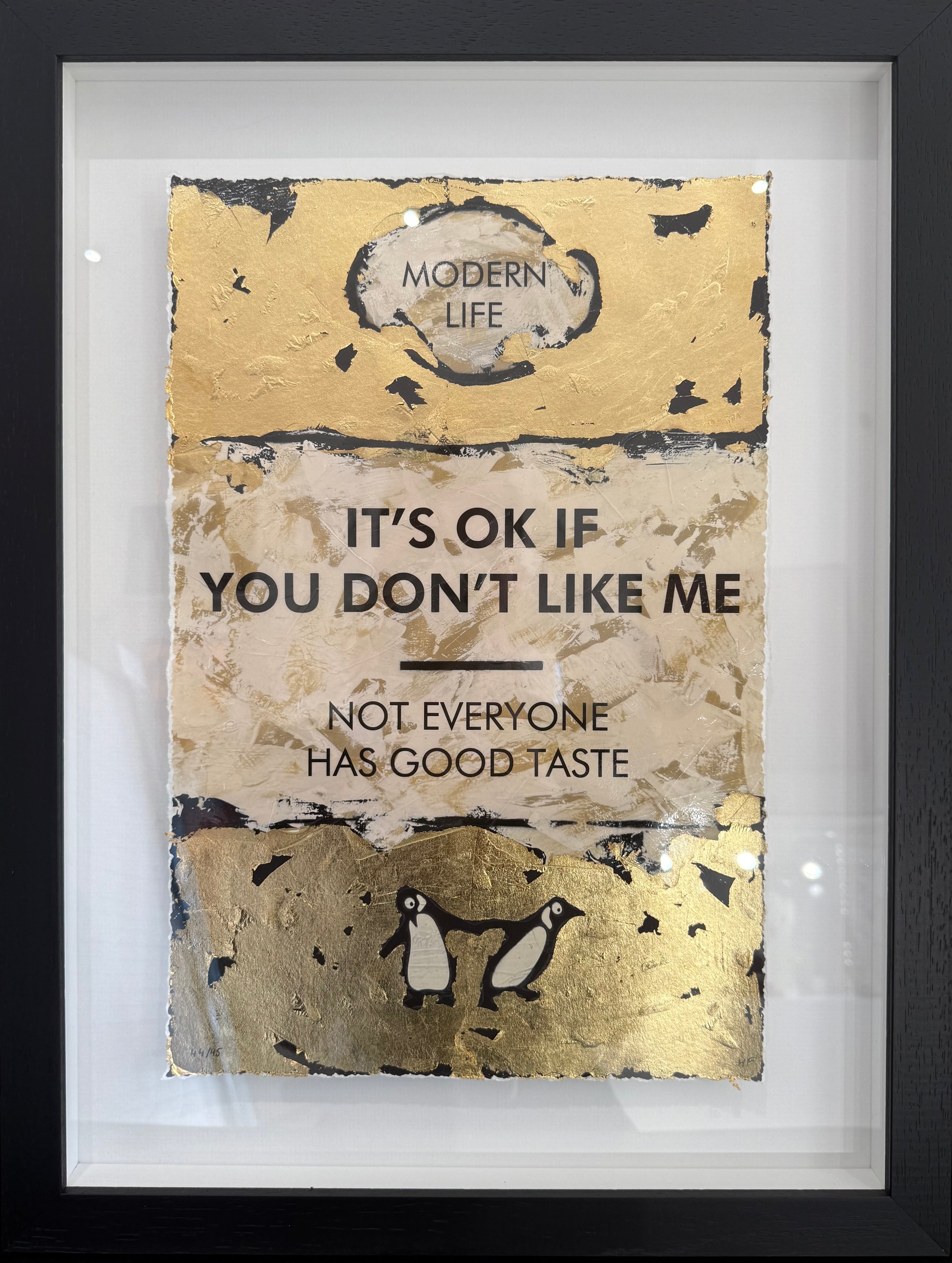 Framed artwork with text 'It's ok if you don't like me. Not everyone has good taste' and penguin illustration.