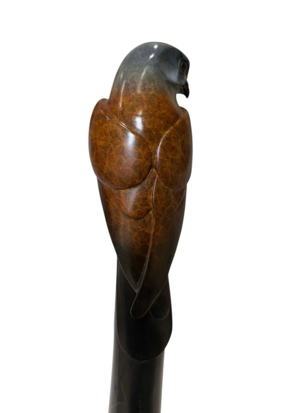 bronze shaped like a kestrel on a white background