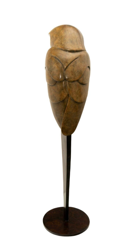 bronze sculpture on a stand against a white background