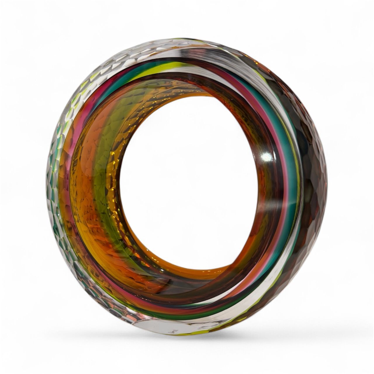 Multicolored glass ring on a white background