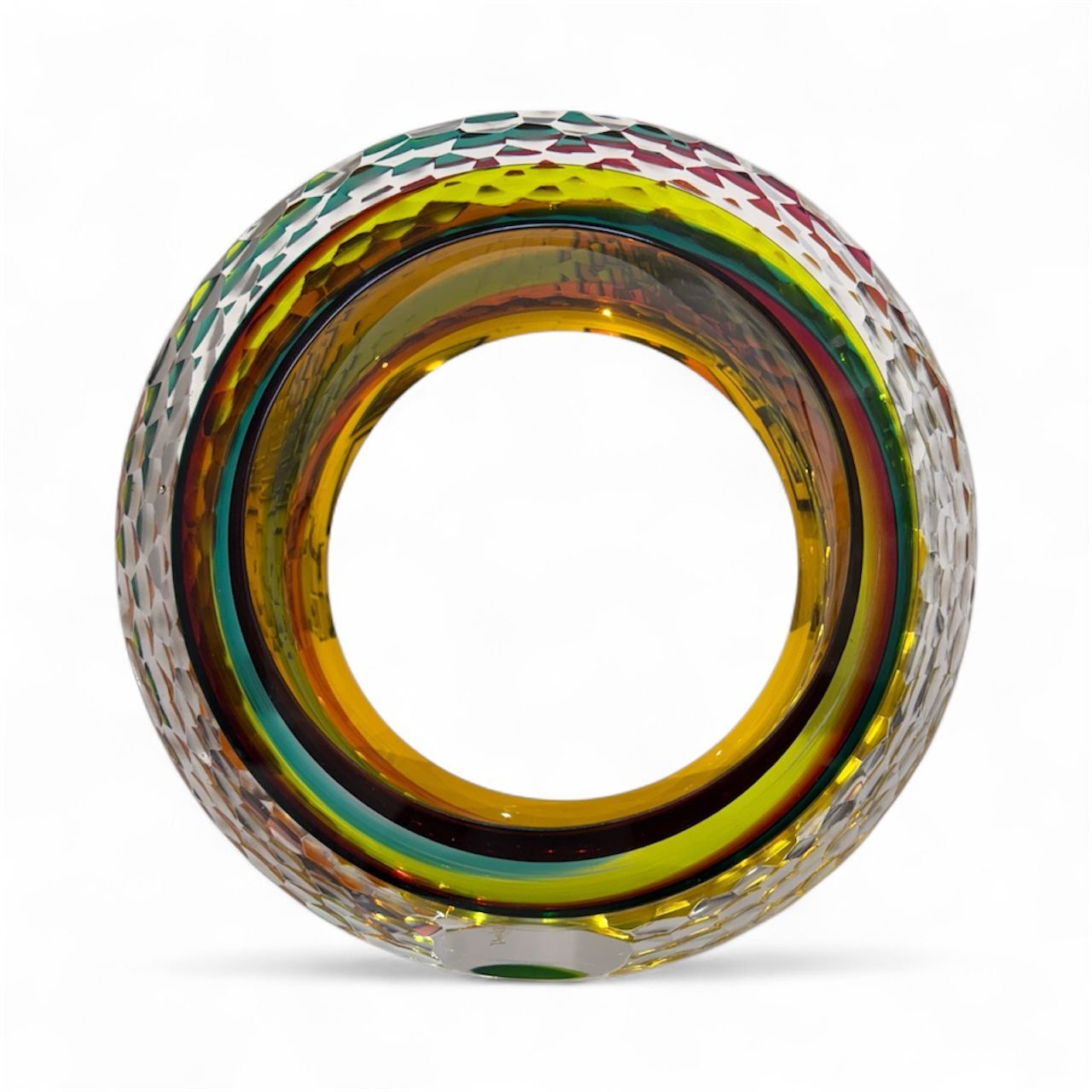 Multicolored glass ring with a textured surface on a white background