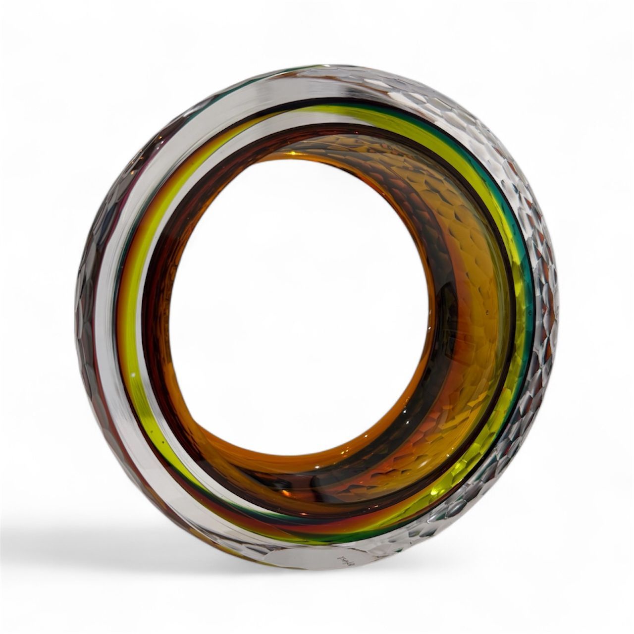 Multicolored glass ring on a white background