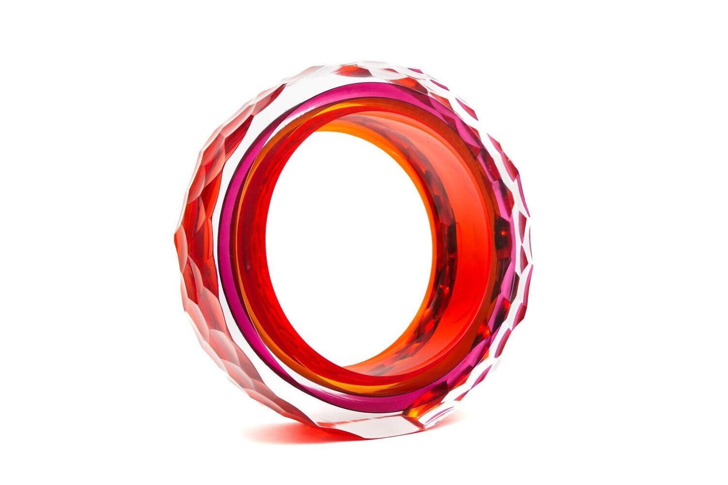 Red and pink glass ring on a white background