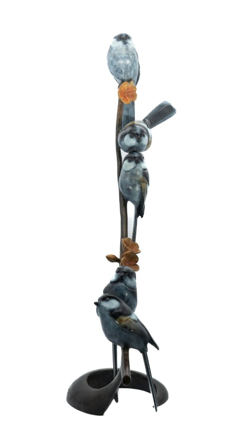 Statue of birds perched on a branch with a white background