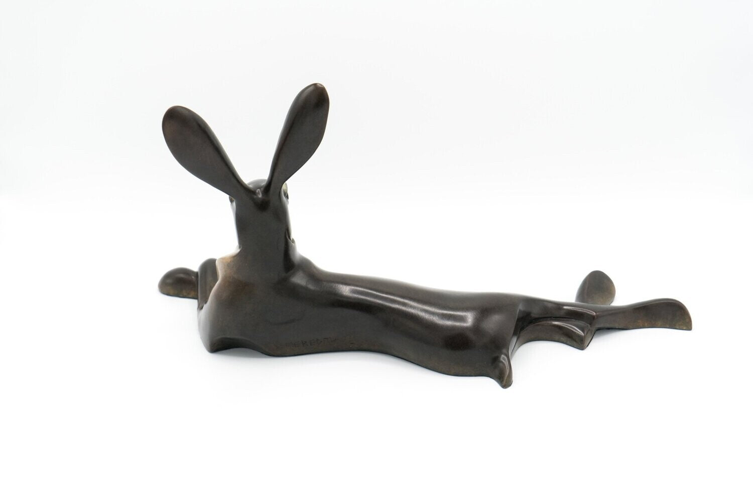 Bronze sculpture of a hare on a white background