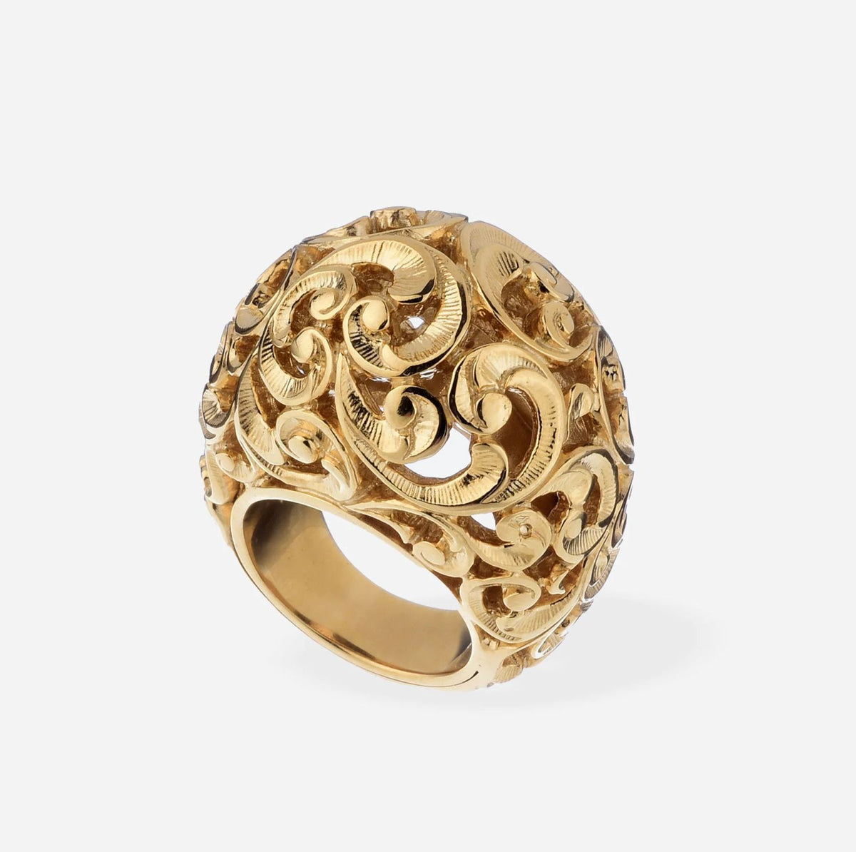 Gold ring with intricate designs on a white background