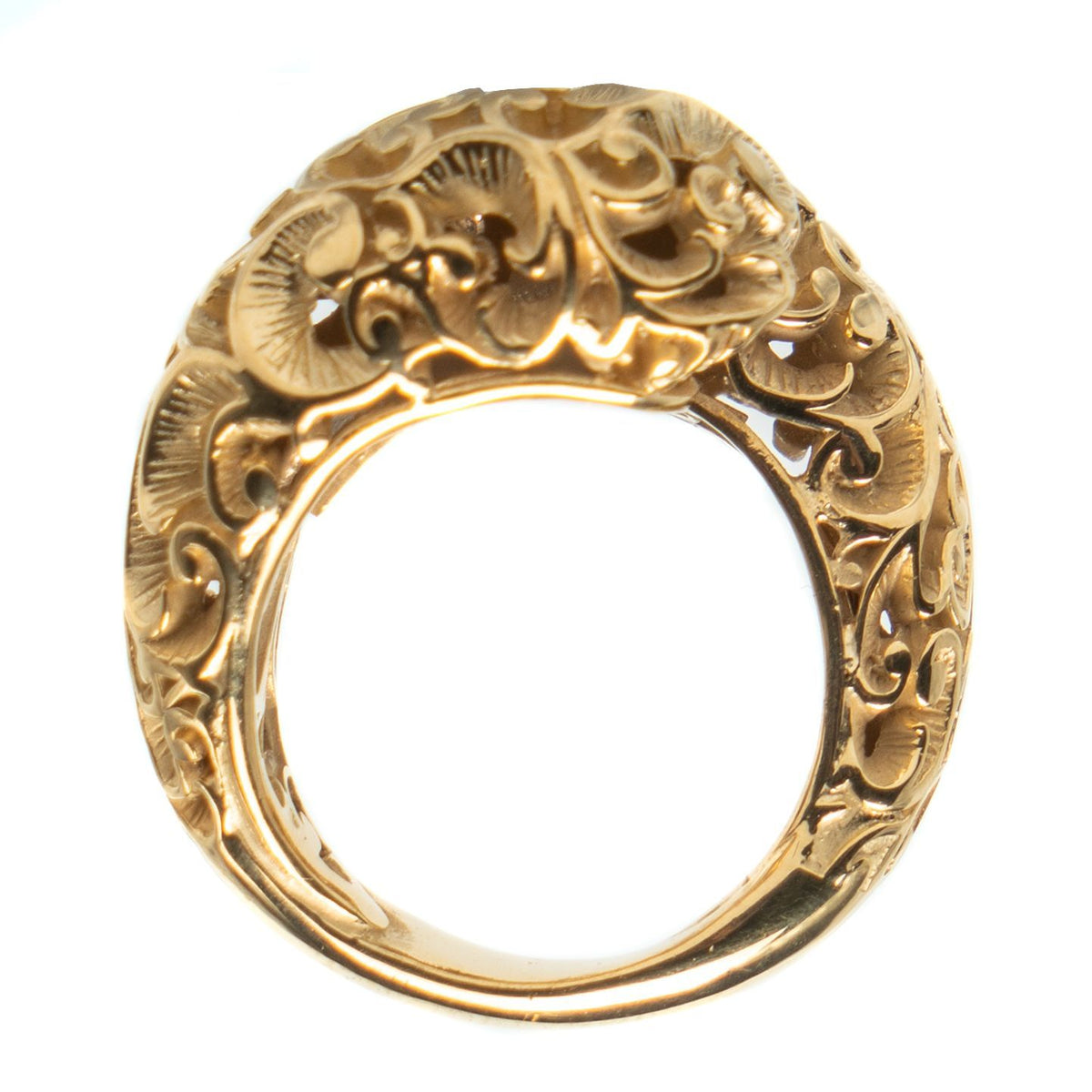 Gold ring with intricate floral patterns on a white background