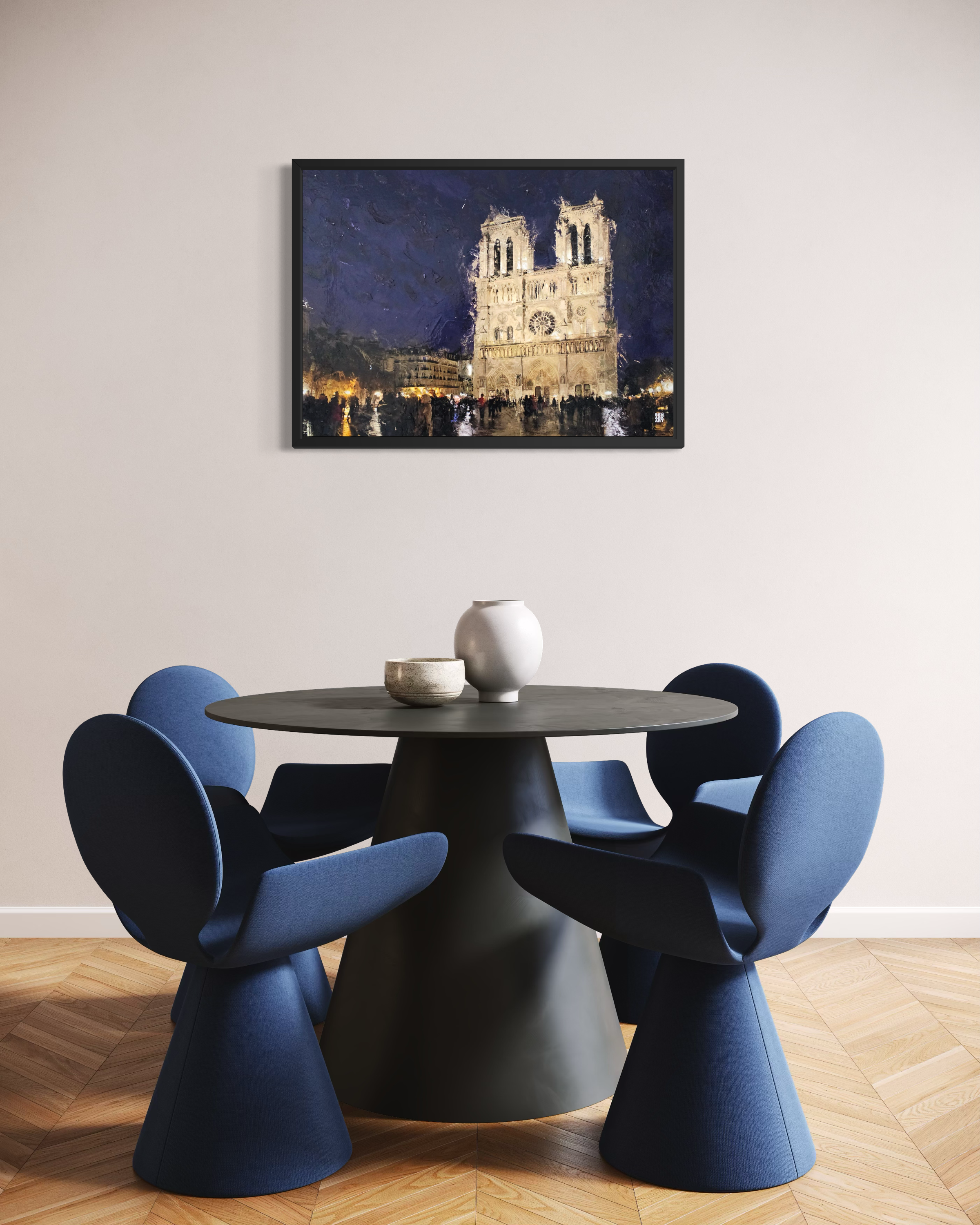 Contemporary interior with a modern black table with navy blue chairs around it under a framed painting of the notre dame hung on the wall centrally