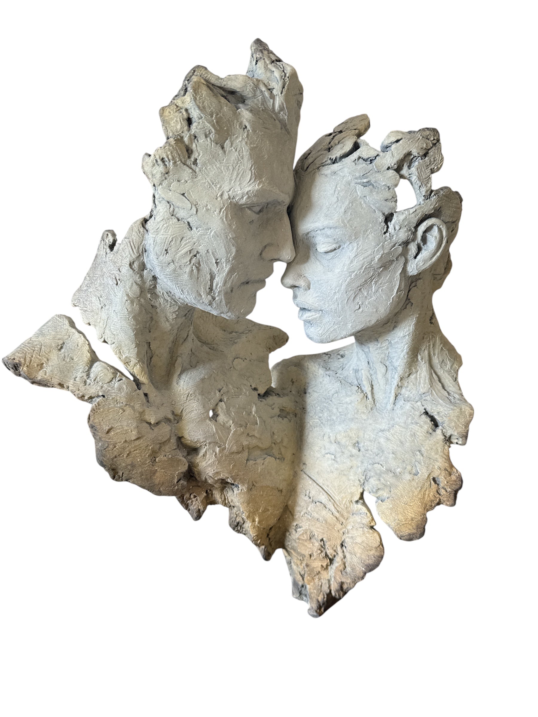 Abstract sculpture of two faces in close proximity on a white background