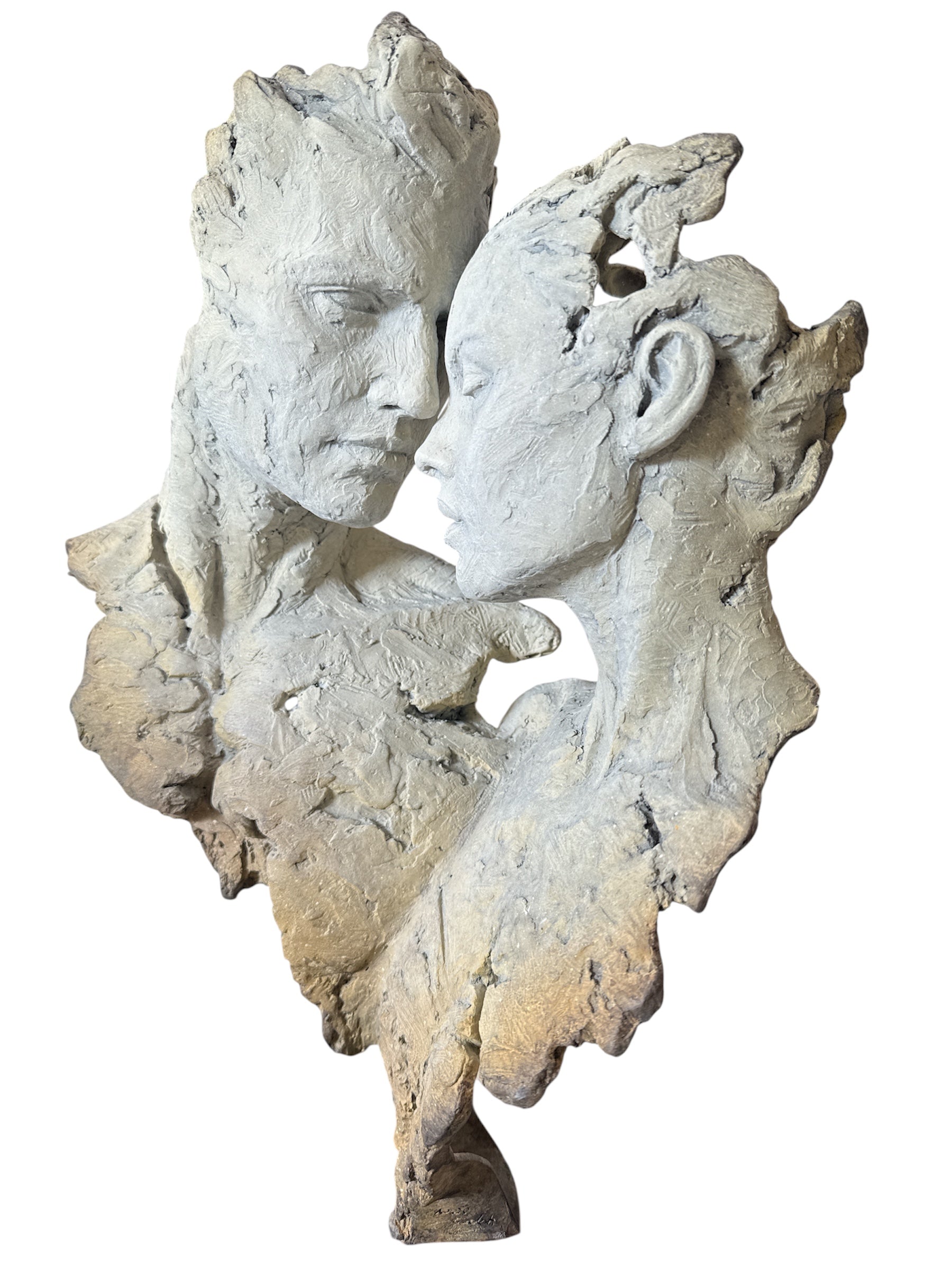 Abstract sculpture of two faces on a white background