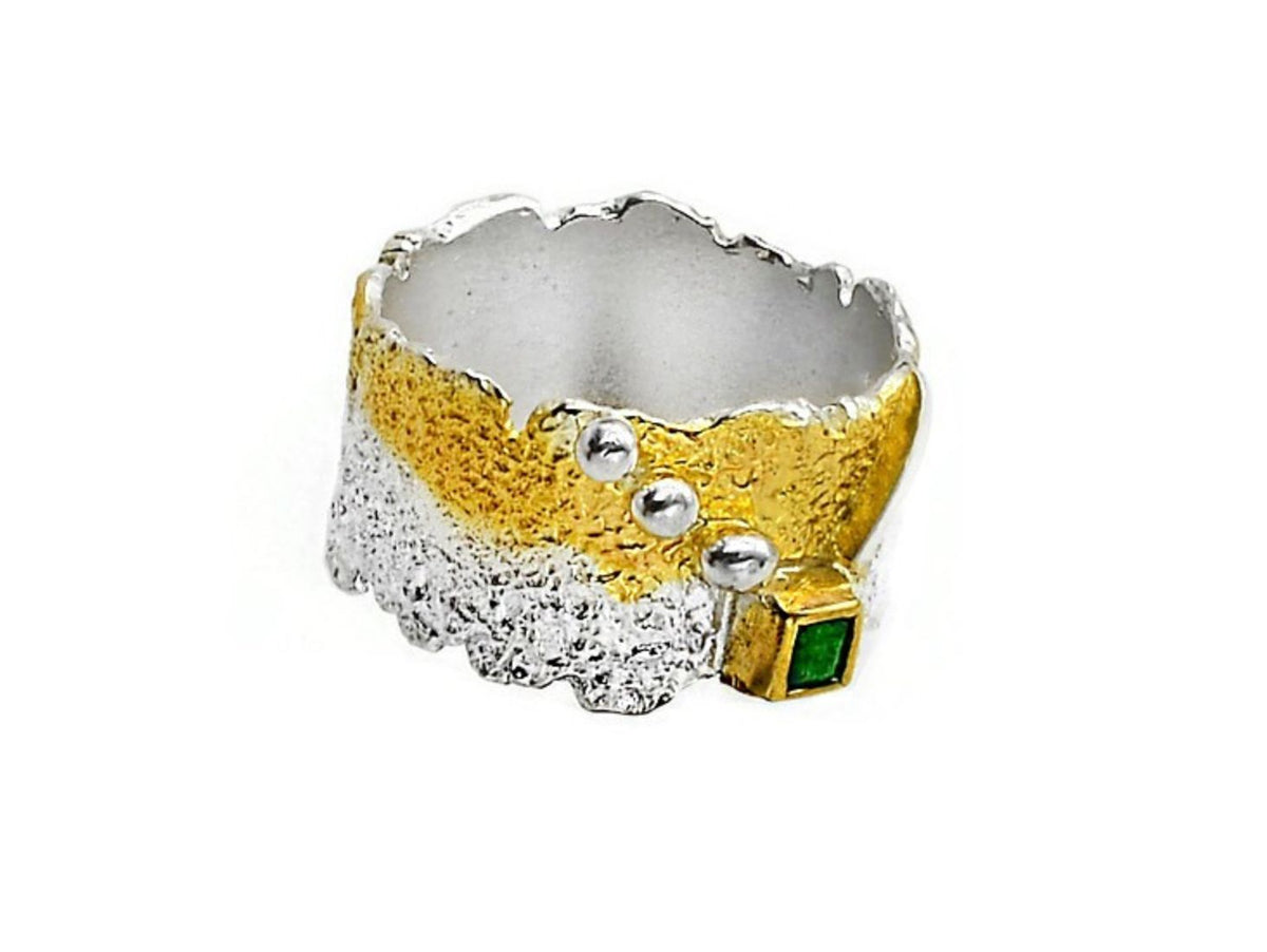 Ring with gold and silver design on a white background