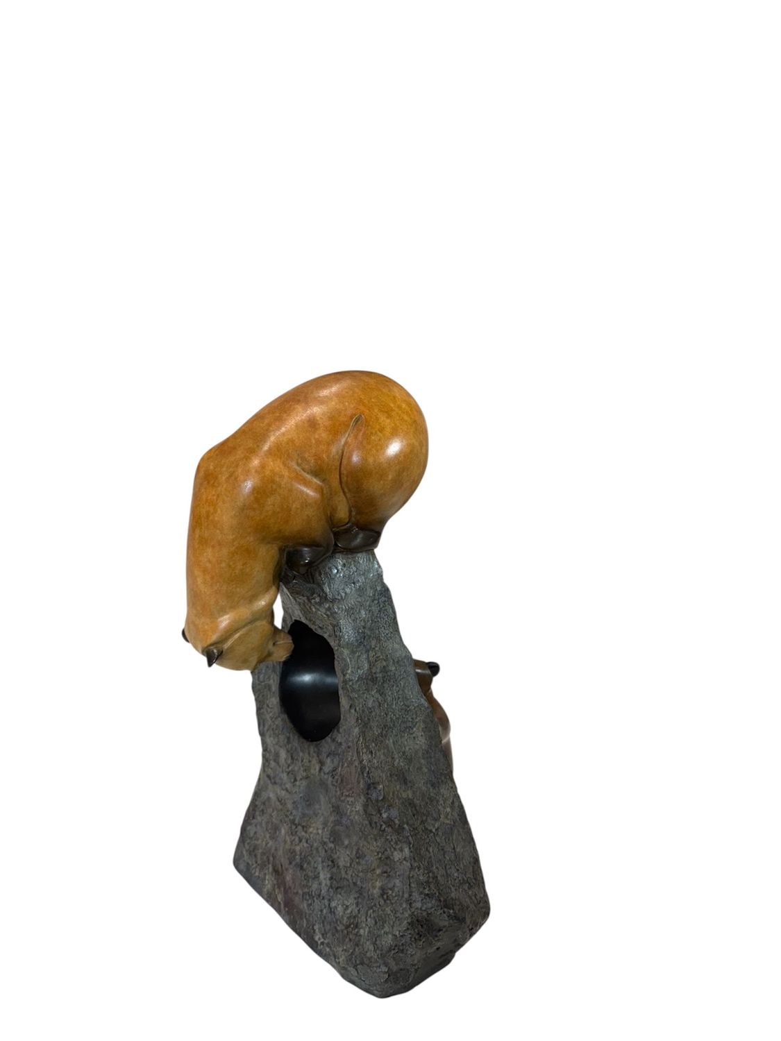 Decorative item with a bronze base on top of a gray stone-like base against a white background
