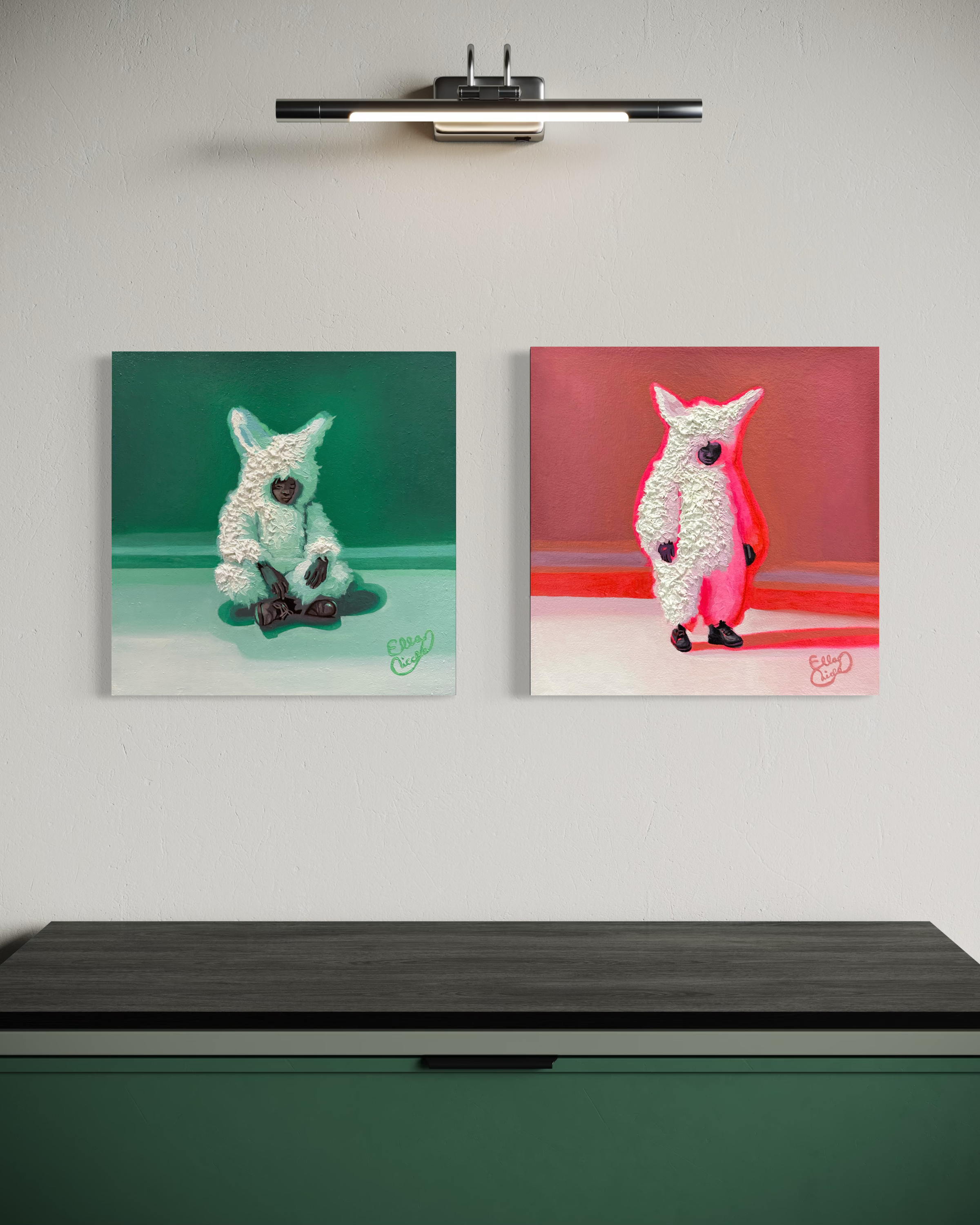 Two paintings of a stylized animal figure on a wall above a desk.