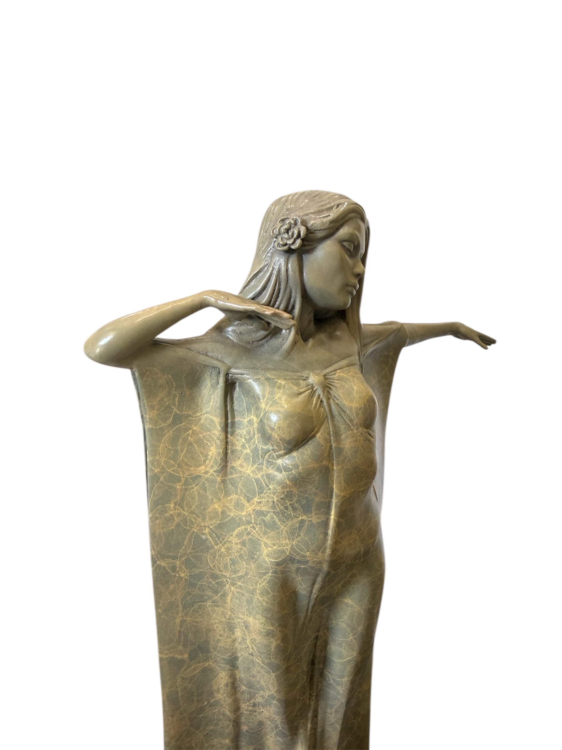 Bronze statue of a woman with flowing hair and a draped garment on a white background
