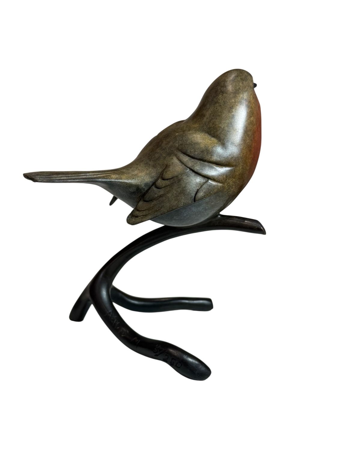 Bronze bird sculpture on a branch against a white background