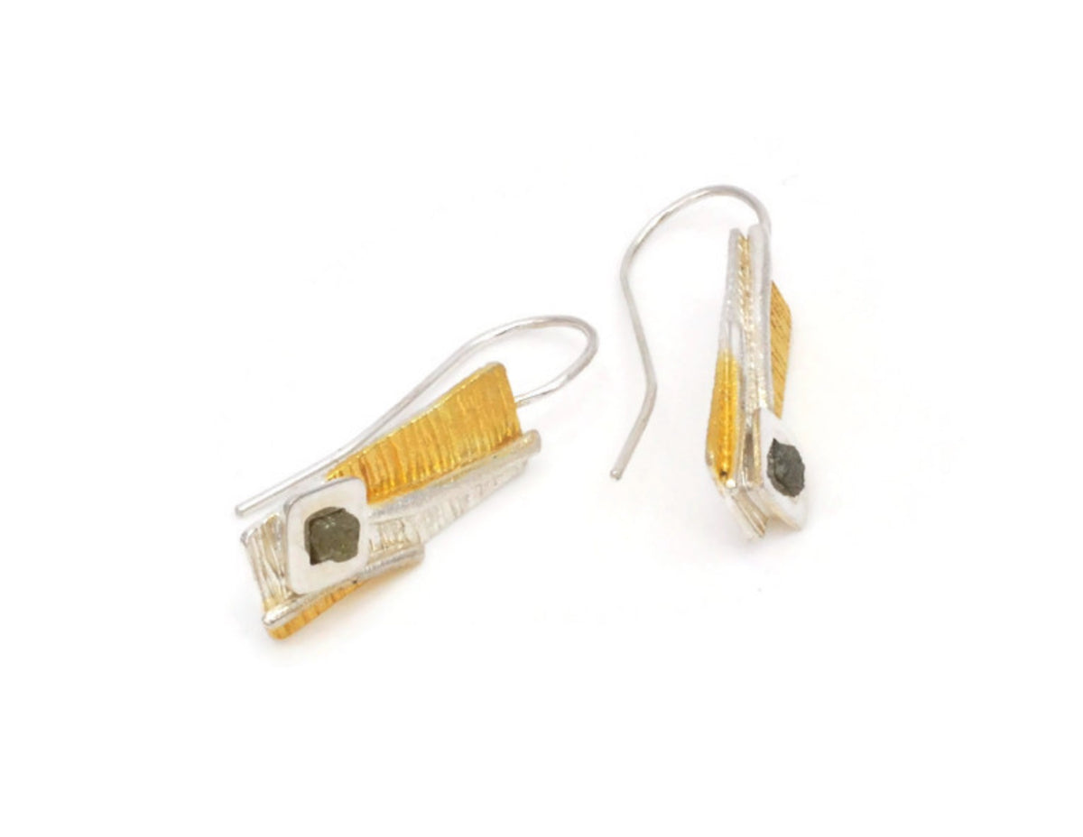 Pair of earrings with gold and silver design on a white background