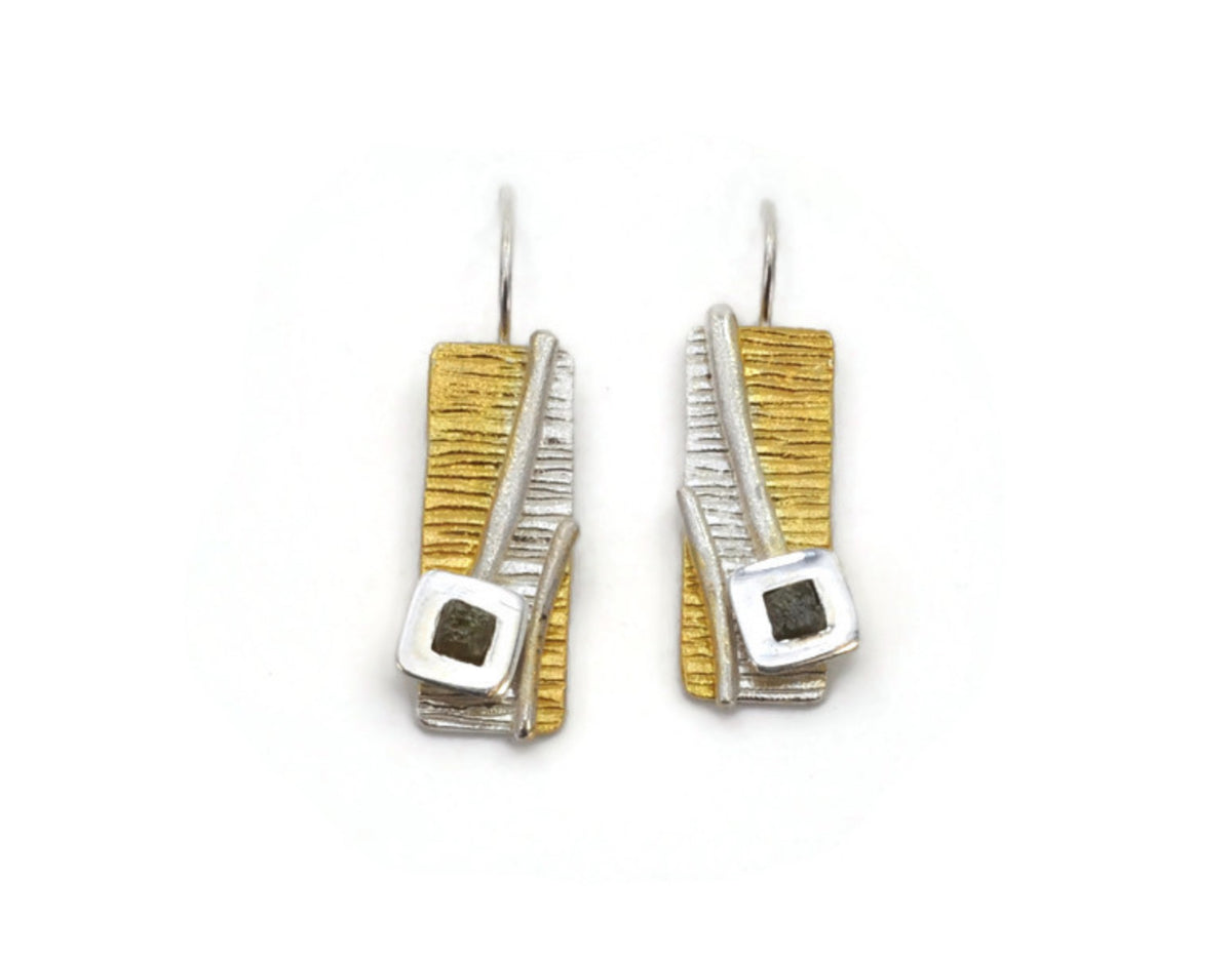 Pair of earrings with gold and silver rectangular designs on a white background