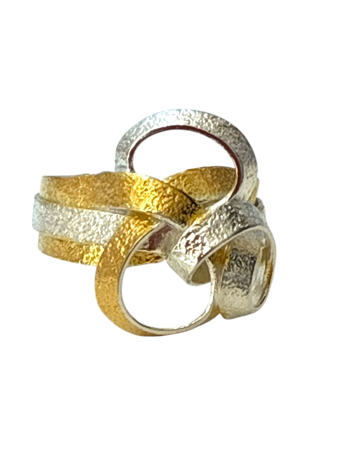 Two gold and silver rings stacked on a white background