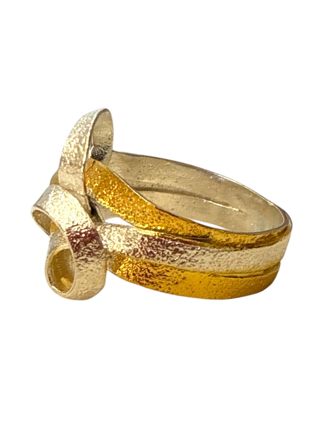 Gold ring with a textured design on a white background