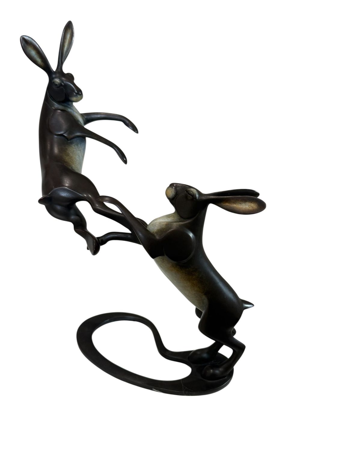 Bronze sculpture of two hares on a white background