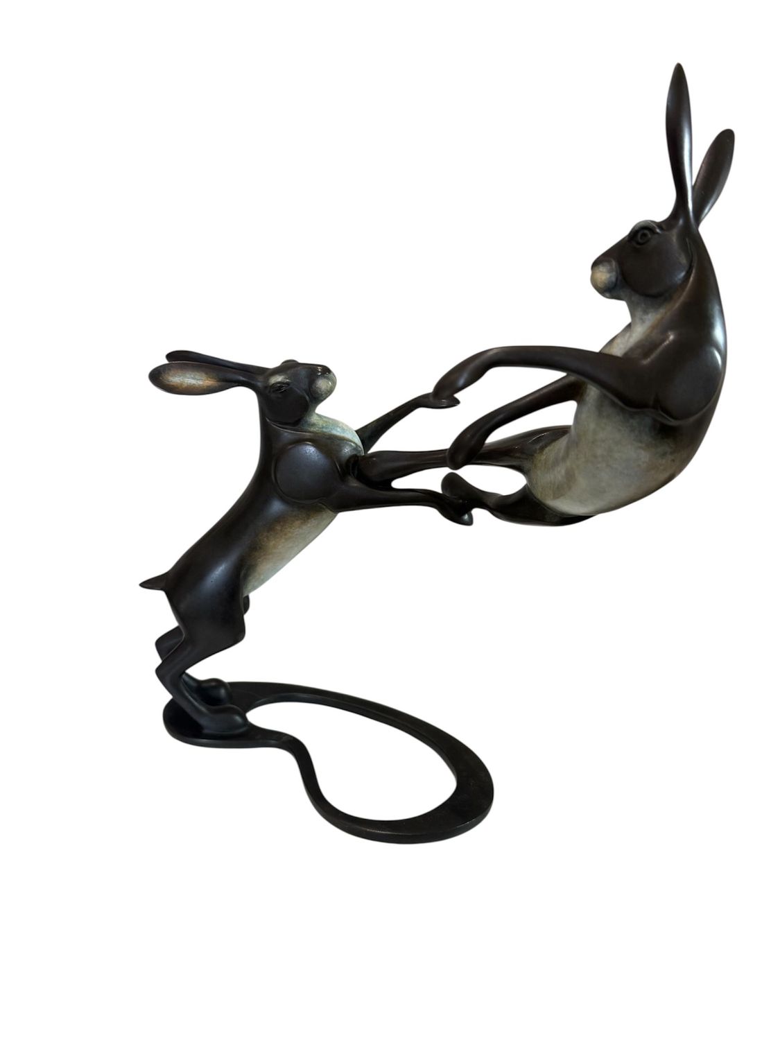 Bronze sculpture of two hares intertwined on a white background