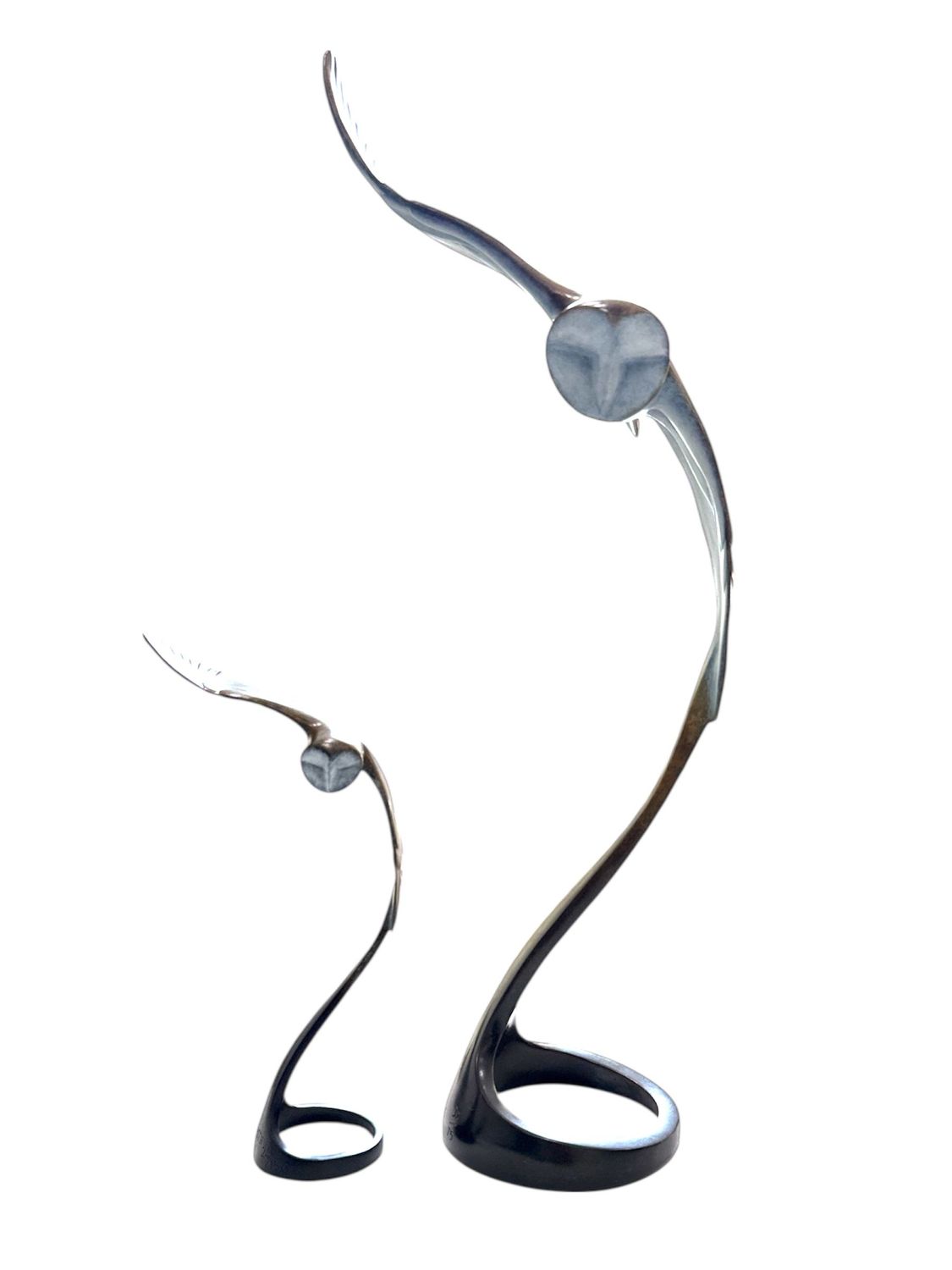 Sculptural object with curved design on a white background