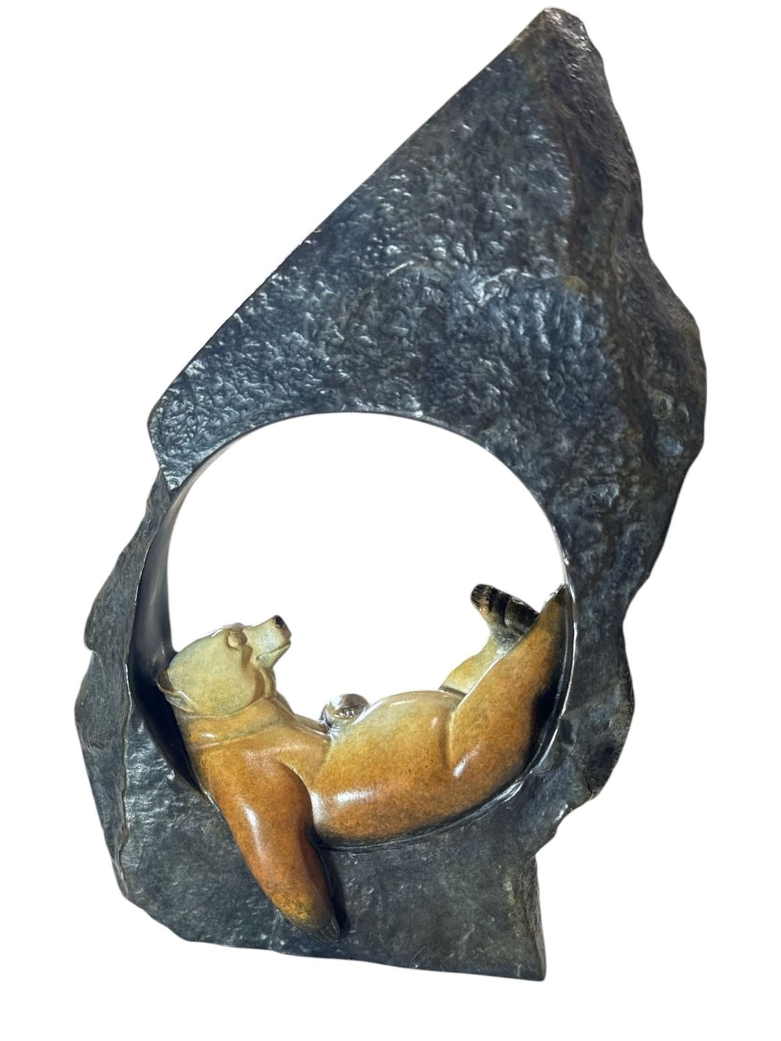 Stone sculpture of a bear inside a naturalistic stone frame