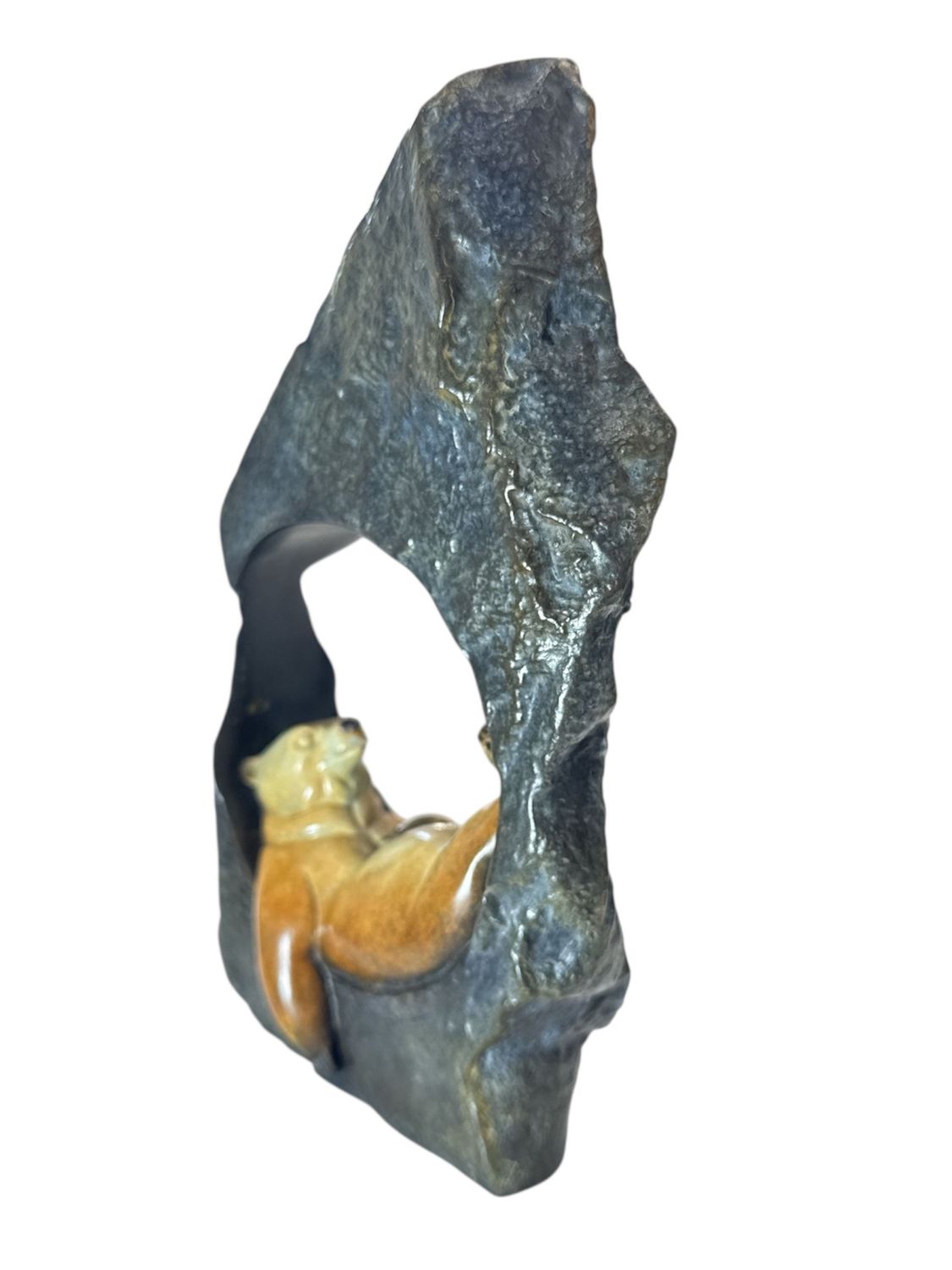 Rock sculpture with a bear inside on a white background