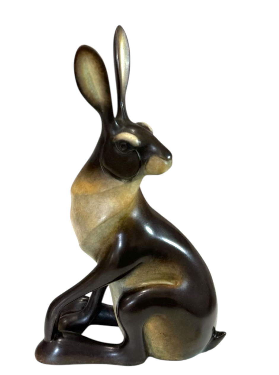 Bronze sculpture of a rabbit on a white background