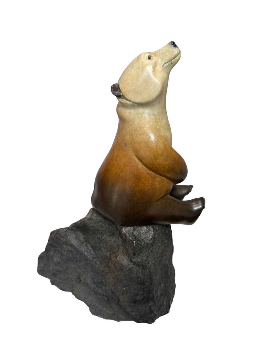 Statue of a bear on a rock with a white background
