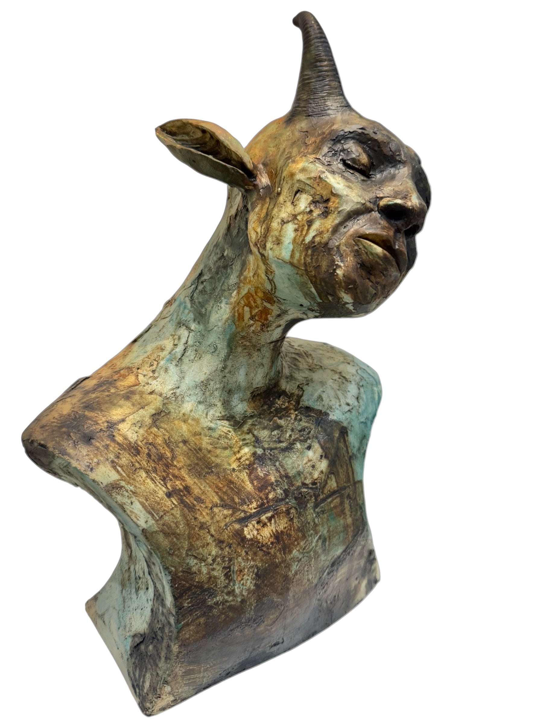 ceramic sculpture of a goat head on a white background