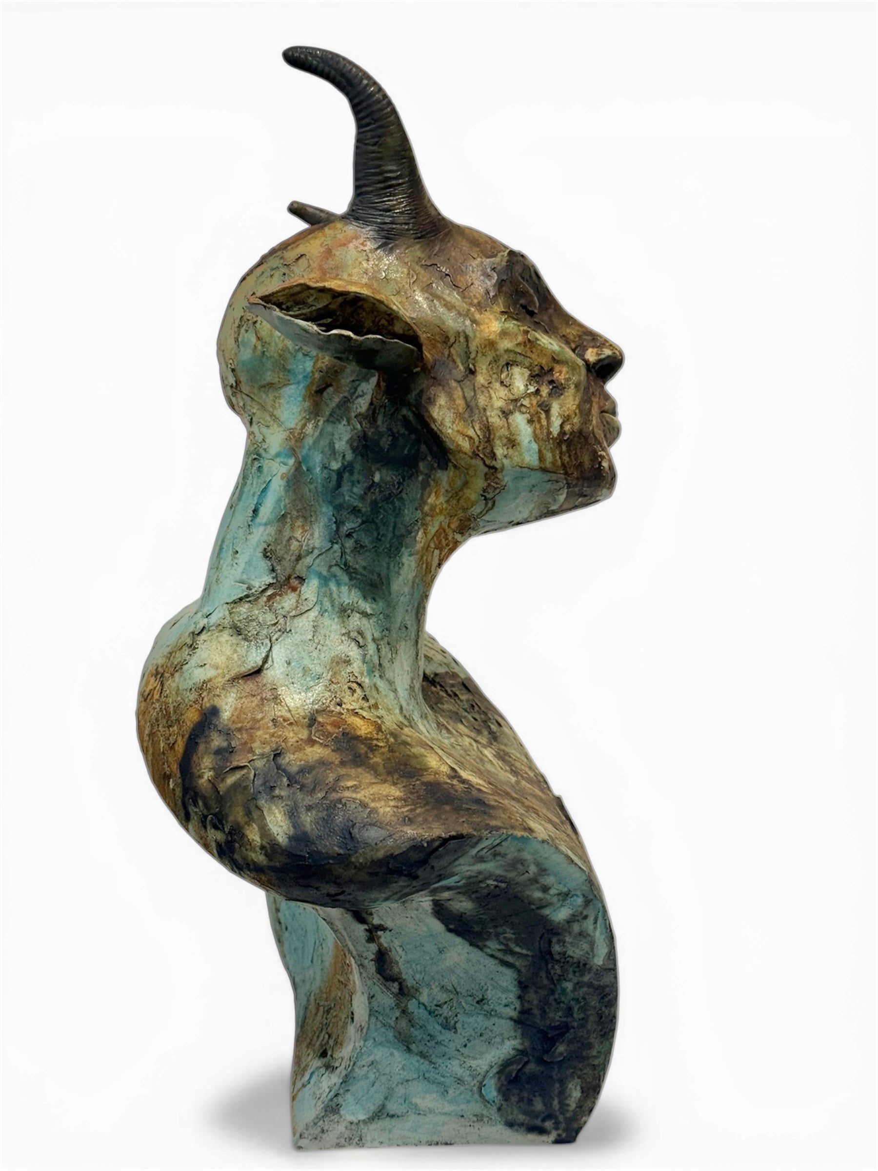 ceramic sculpture of a goat like figure with a white background