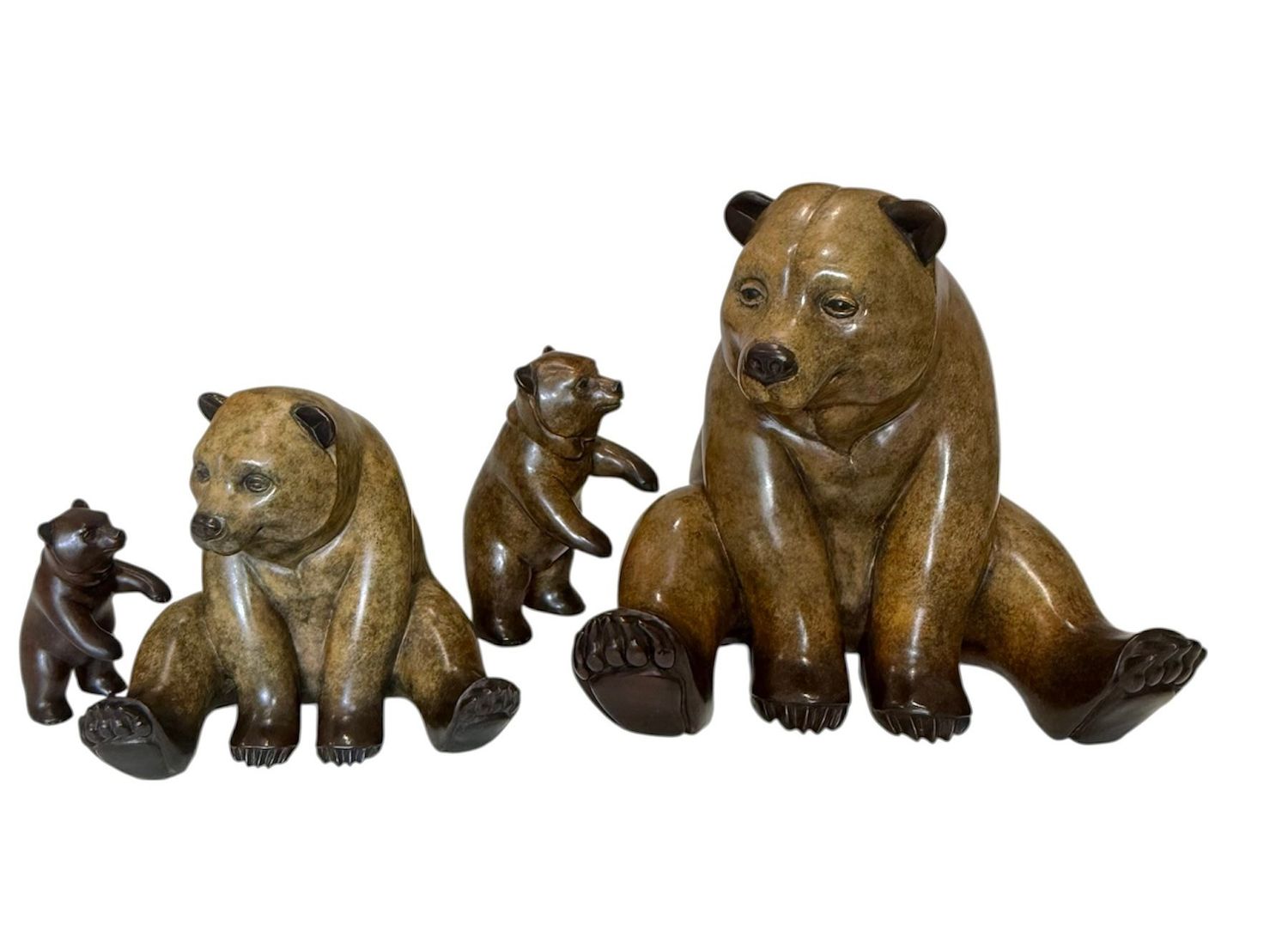 Set of four brown bear figurines on a white background